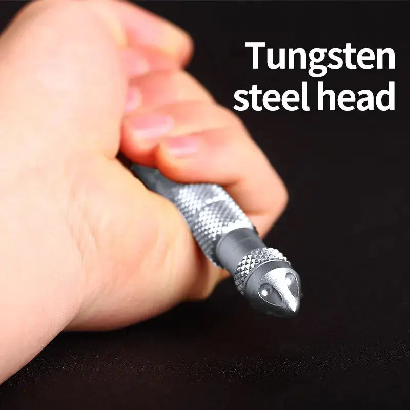 Metallic tactical defense pen with tungsten steel head in a hand, showcasing durability