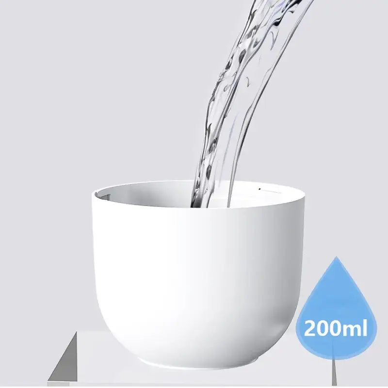 White ceramic cup filled with clear liquid from Balashov Mini Ultrasonic Air Humidifier