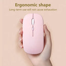 Pale pink ergonomic Bluetooth mouse held in hand for seamless comfort and convenience