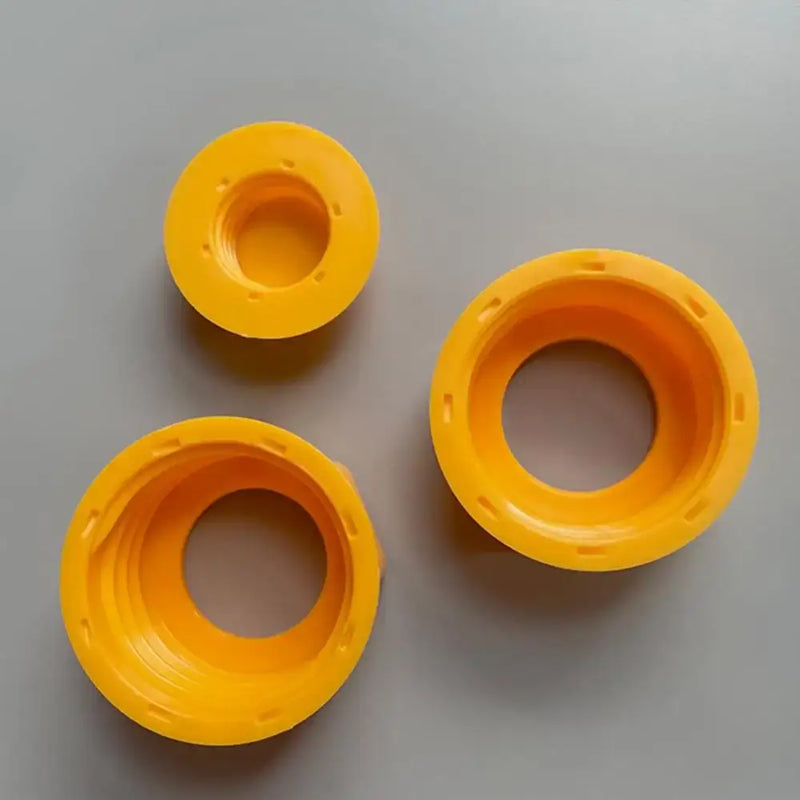 Three yellow circular plastic hexagonal nut plugs for hand tool maintenance and repair