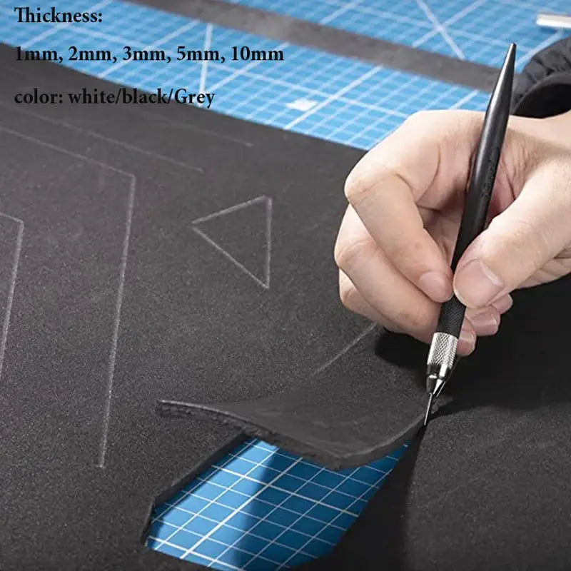 Cutting high-quality 10mm EVA foam sheets on a gridded surface with a craft knife