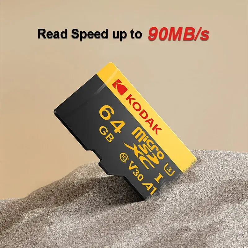 Kodak microSDXC Memory Card with V30 Video Speed Class partially buried in sand