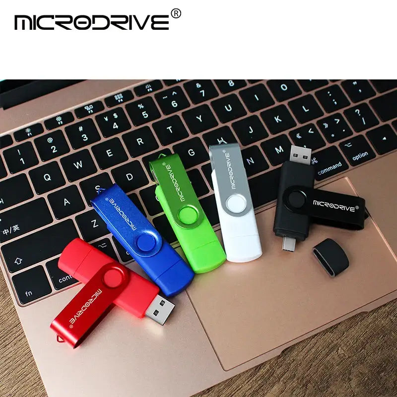 Colorful USB flash drives on a laptop keyboard featuring MicroDrive CK016G0OTG Flash Disk