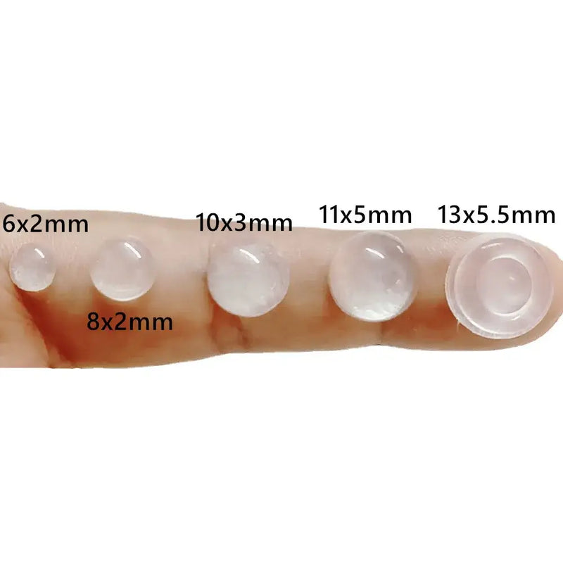 Clear silicone pads of varying sizes on fingertip demonstrating NoEnName Null Adhesive Door Stopper