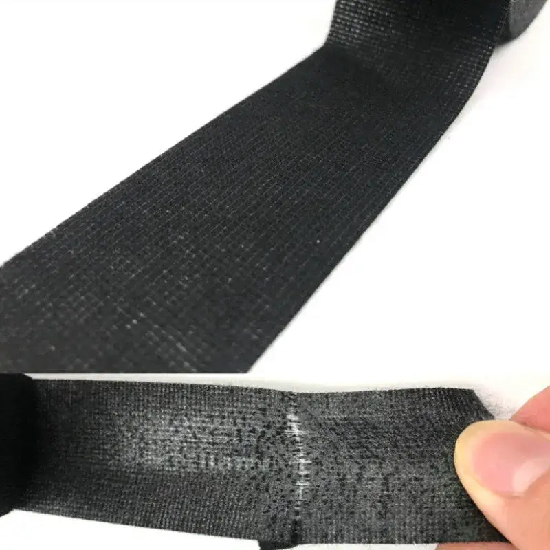 Black elastic fabric tape being stretched, ideal for DIY electrical supplies from Mainland China