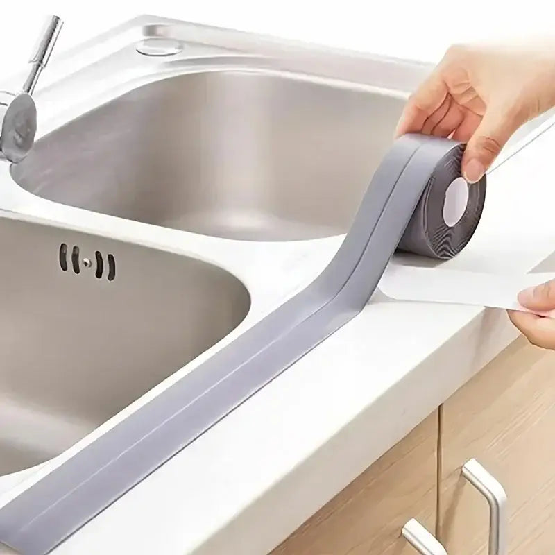 Adhesive PVC waterproof sealing strip applied by NoEnName Null around kitchen sink edge