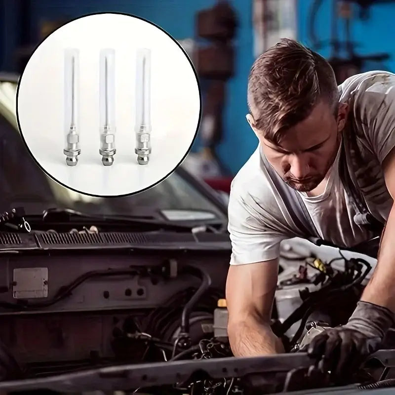 Mechanic using NoEnName Null Item Grease Guns on a car engine with spark plugs shown