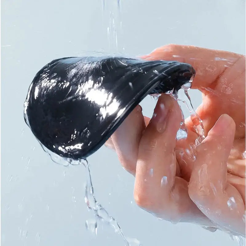 Black rubber balloon filled with water being squeezed, perfect for compact solid car air freshener