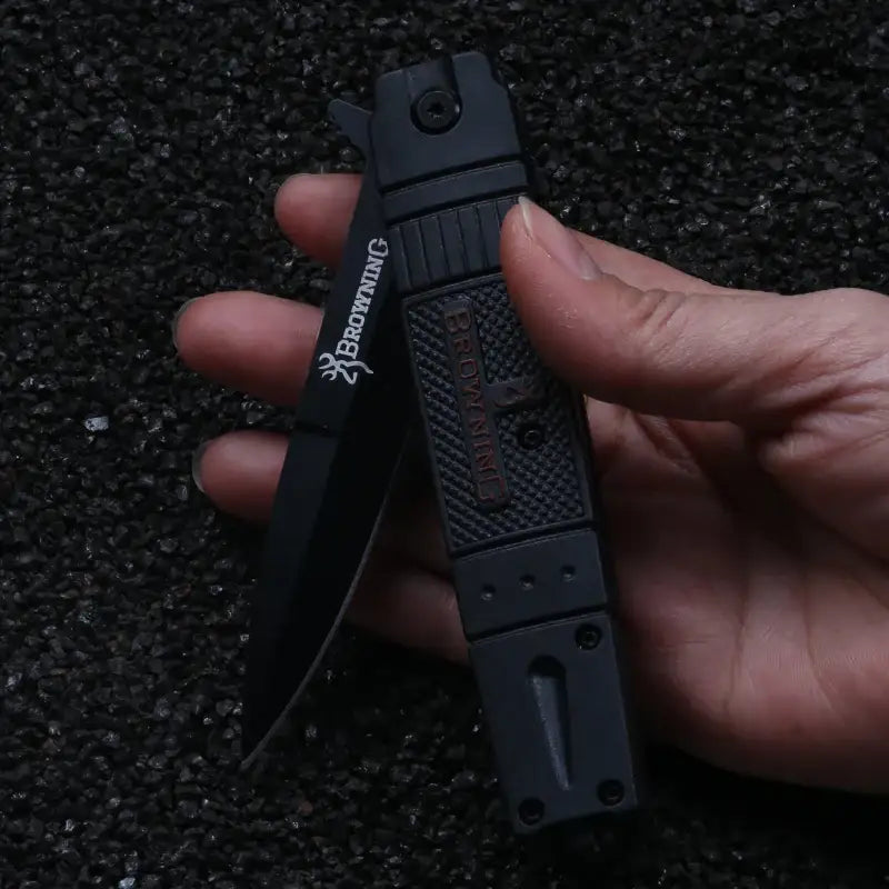 Black folding pocket knife in hand, ideal for NoEnName_Null stainless steel metalworking