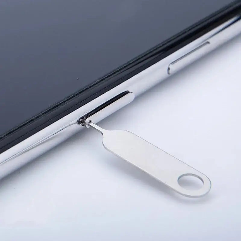 SIM card ejector tool inserted into NoEnName_Null Steel SIM card tray for smartphones