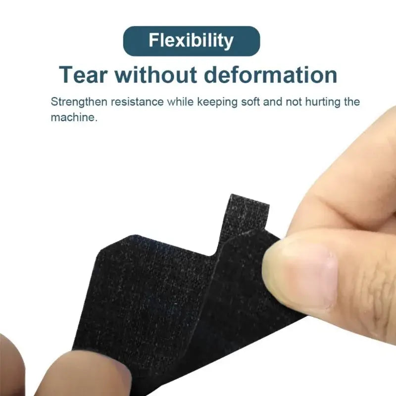 Black flexible material stretched by fingers showcasing tear-resistant properties of NoEnName Universal Phone Lanyard from Mainland China