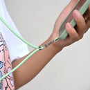 Hand unzipping a mint green zipper on an adjustable detachable cord lanyard strap