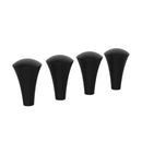 Four black silicone caps for X-Grip Holder phone accessories arranged in a row