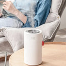Cylindrical Sokany Portable Humidifier with 2000mAh battery emitting mist on wood
