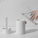 Cylindrical Sokany Portable Humidifier being filled with water from a pitcher