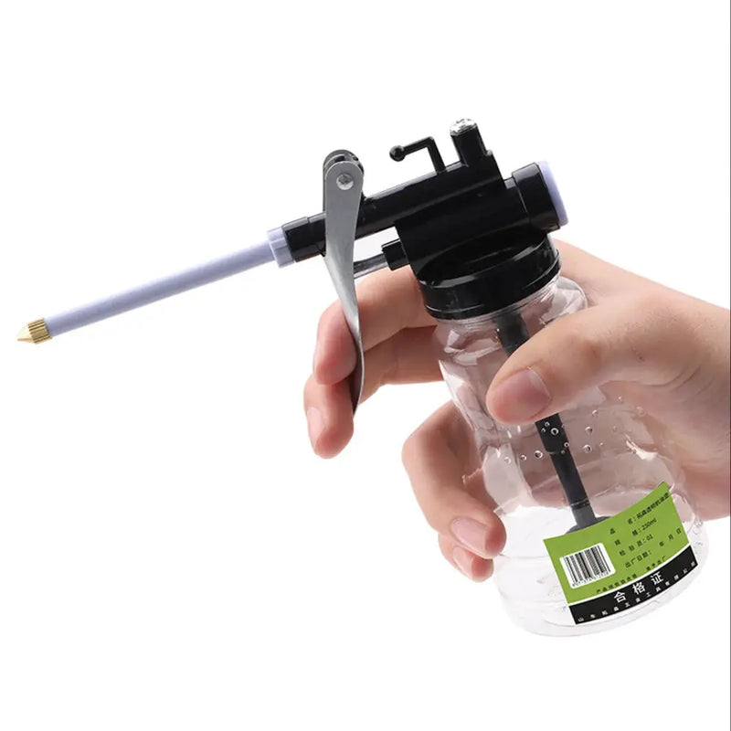 Handheld pump sprayer attached to a clear bottle for SONONIA High Pressure Pump Oiler