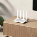 White Xiaomi AX3000T Router with four antennas on a wooden surface for stable connections